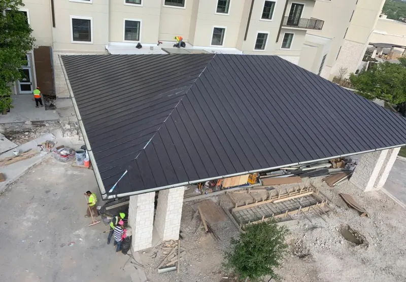 Metal roofing installation team working on a commercial building in Gold Canyon